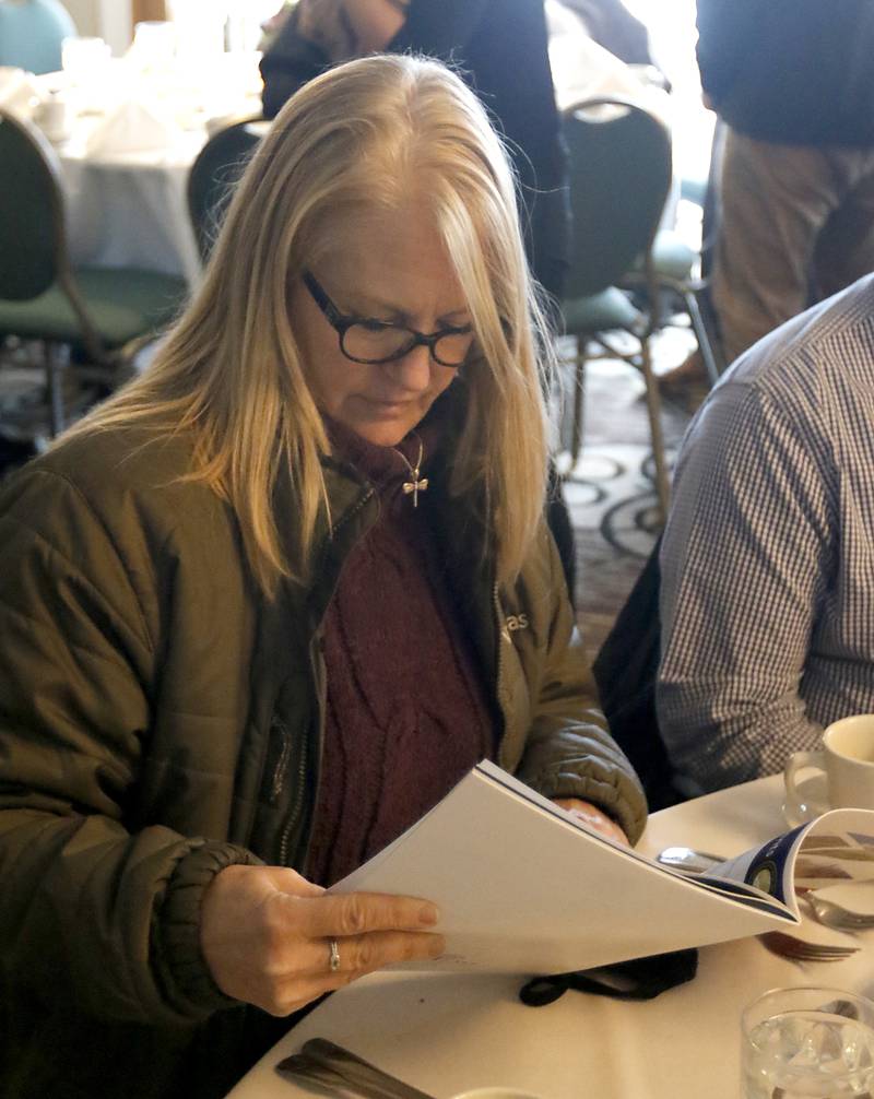 Melissa McConnell, of Nicor Gas, looks at the State of the Community report during the Crystal Lake Chamber of Commerce’s State of the Community Luncheon, Friday, Feb. 4, 2022, at D'Andrea Banquets & Conference Center. The annual luncheon feature guest speakers Crystal Lake Mayor Haig Haleblian and Village of Lakewood President David Stavropoulos who spoke about their respective communities.