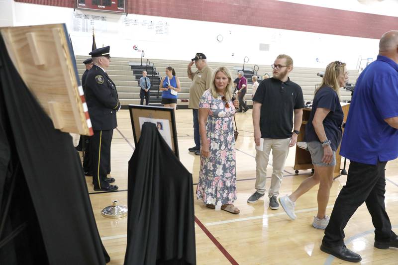 Members of the public file past the remains of Kane County Sheriff K9 Hudson during a funeral in honor of the Dutch shepherd, who lost his life in the line of duty last month, on Thursday, June 1, 2023 at Kaneland Harter Middle School in Sugar Grove.