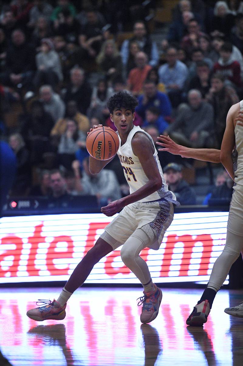 John Starks/jstarks@dailyherald.com
Rolling Meadow’s Cameron Christie controls the ball against Lyon Township in the Jack Tosh boys basketball tournament at York High School in Elmhurst on Friday, December 30, 2022.