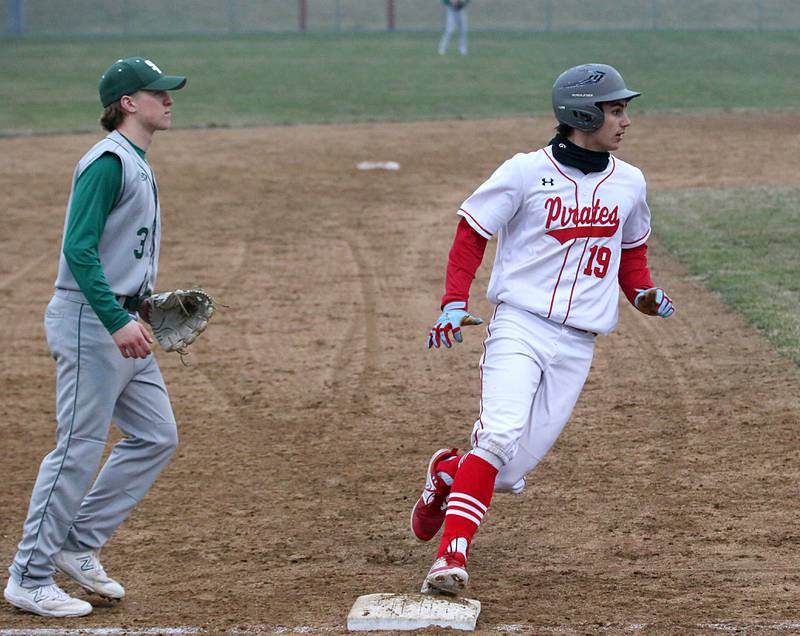 Ottawa's Payton Payton Knoll rounds third base as St. Bede's Callan Cueneburg watches the ball on Wednesday, March 22, 2023 at Ottawa High School.
