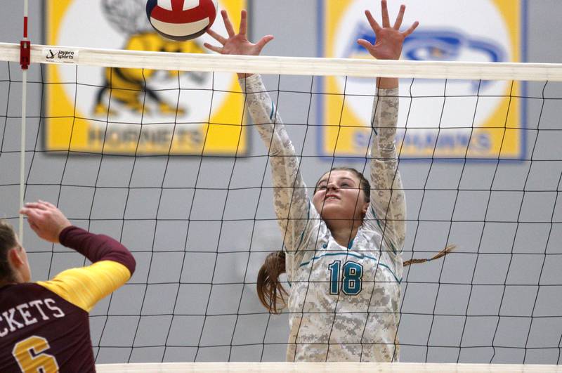 Woodstock North’s Gabriella Schefke blocks against Richmond-Burton in varsity volleyball at Woodstock Monday night.