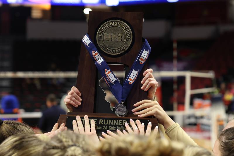 IC Catholic holds up the Class 2A State Runner-Up trophy after their loss against Mater Dei in the Class 2A Volleyball Championship match on Saturday, Nov. 11, 2023 in Normal.