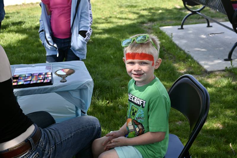 Josiah Gomez, 3, of Somonauk smiles during his face painting on Sunday, May 18, 2025 during Kites in Flight at Peck Park in Ottawa.