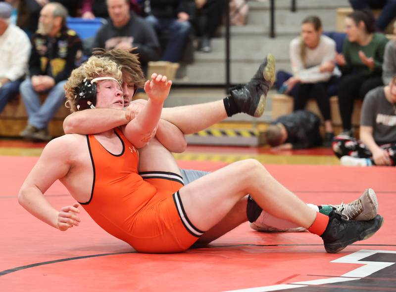 Yorkville's Hunter Janeczko, in grey, goes up against against Minooka's Hunter Coons during the Southwest Prairie Conference wrestling meet at Yorkville High School on Saturday, Jan. 21, 2023.