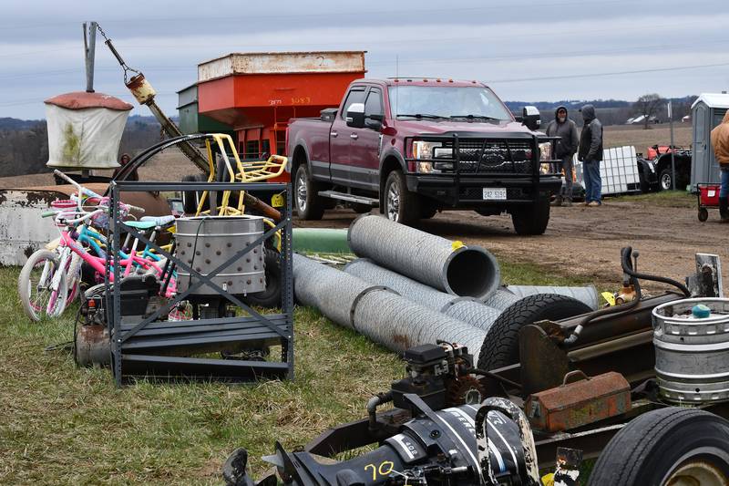 A truck pulls a wagon by one of the "miscellaneous" rows of auction items at the Spring Hazelhurst Consignment Sale on Saturday, April 4, 2026.