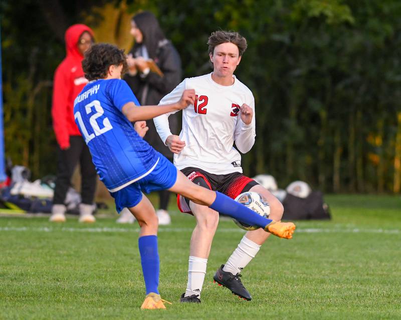 Indian Creek's Lucas Odle, left, kicks the ball away from Hinckley-Big Rock's Jacob Orin in the first half of the game Monday Sept. 26th held at Hinckley-Big Rock High School.
