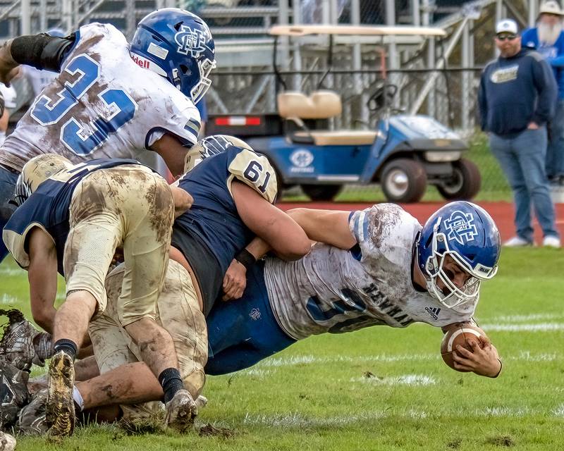 Newman's Ethan Van Landuit dives forward for a few extra yards during Saturday's Class 2A first-round playoff game against Mercer County in Aledo.