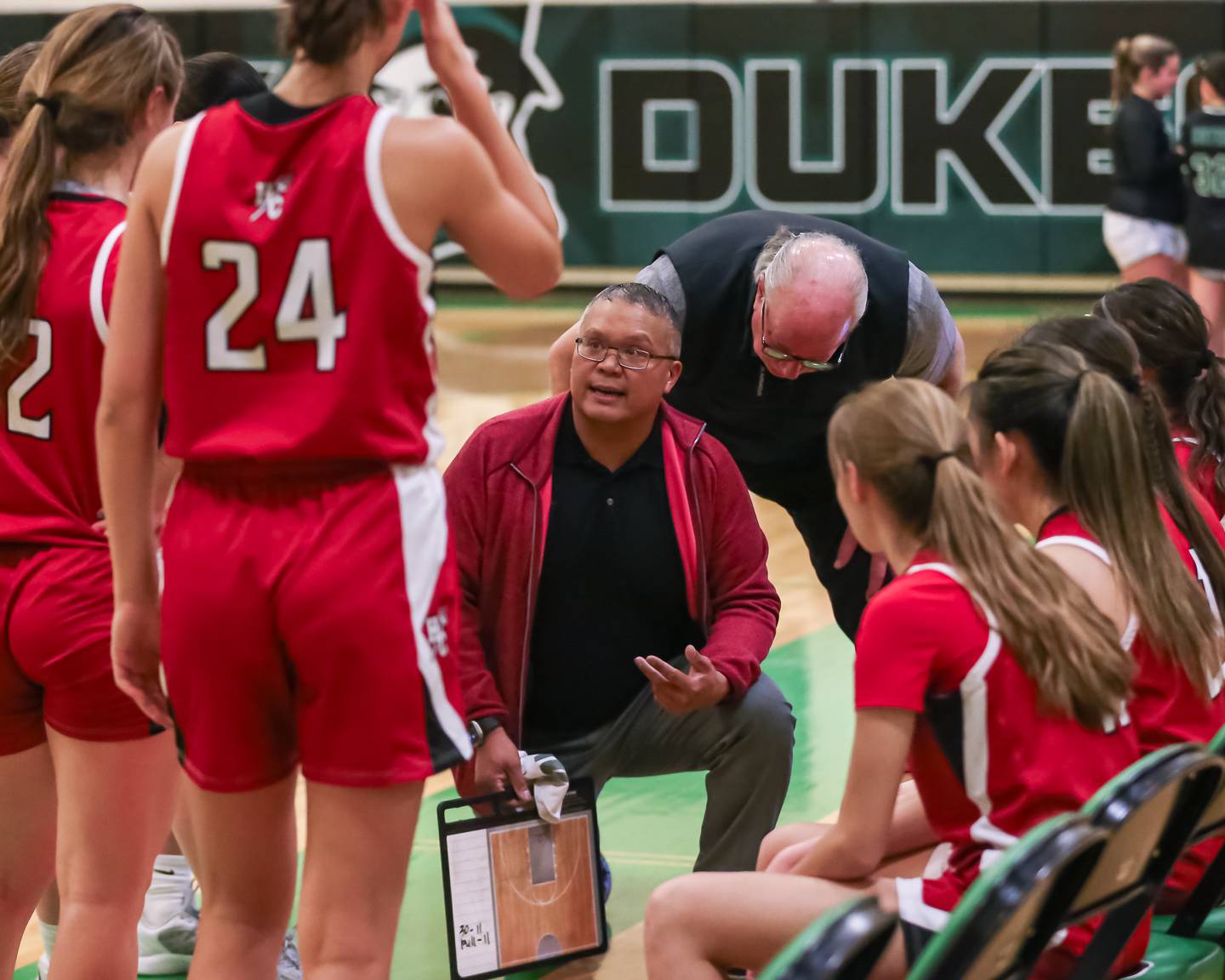 Hinsdale Central's head coach Ryan Sasis instructs the team during a timeout in their basketball game at York. Dec 8, 2023.