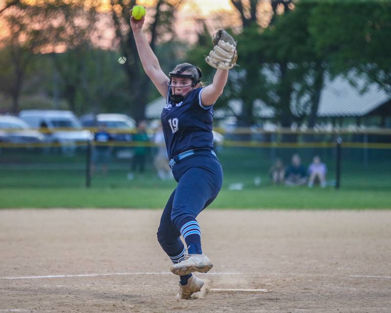 Downers Grove South's Ella Cushing (19) winds up to deliver a pitch during varsity softball game between Downers Grove South at Downers Grove North.  May 11, 2023.