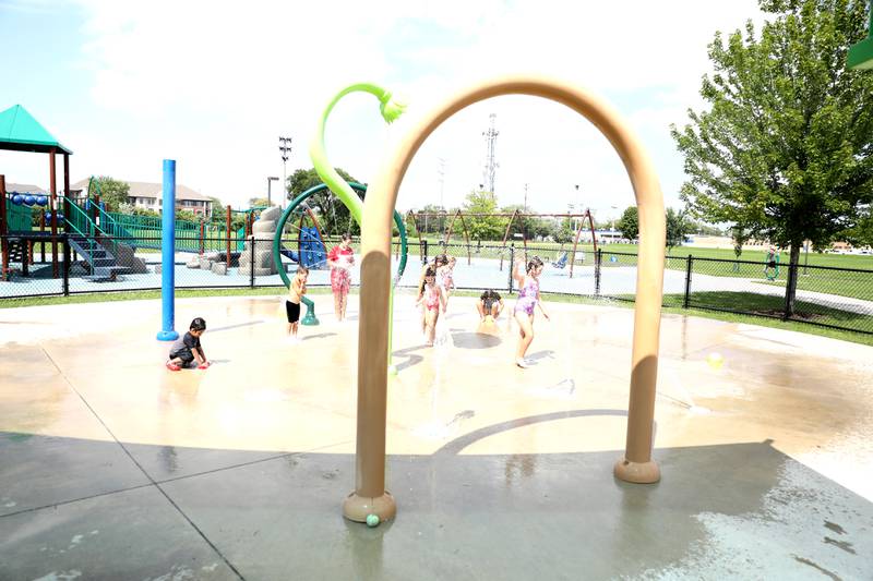 Children play in the water at the Gordon Park Splash Pad in La Grange as temperatures hit the 90s on Friday, July 28, 2023.
