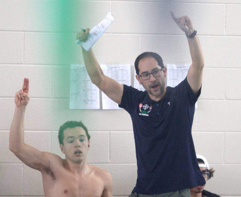 Head Coach Scott Lattyak of Cary-Grove co-op guides his team during the Fox Valley Conference Swimming Championships at Woodstock North High School Saturday.