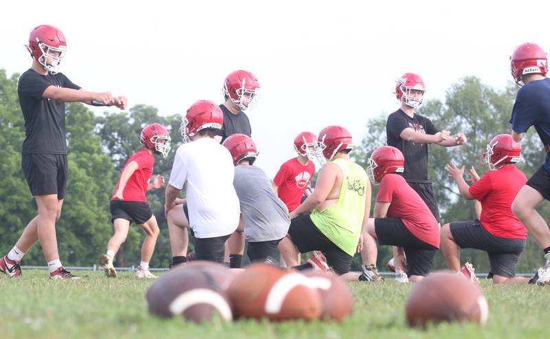 Members of the Hall high School football team run drills during camp on Thursday, July 24, 2025 at Hall High School.