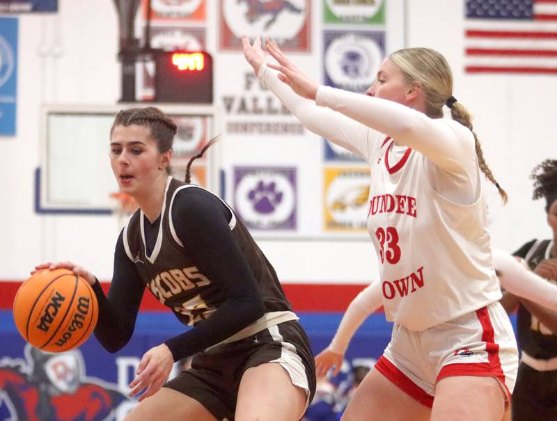 Jacobs’ Olivia Schuster works under the hoop  in varsity girls basketball on Friday, Dec. 12, 2025, at Dundee-Crown High School in Carpentersville.
