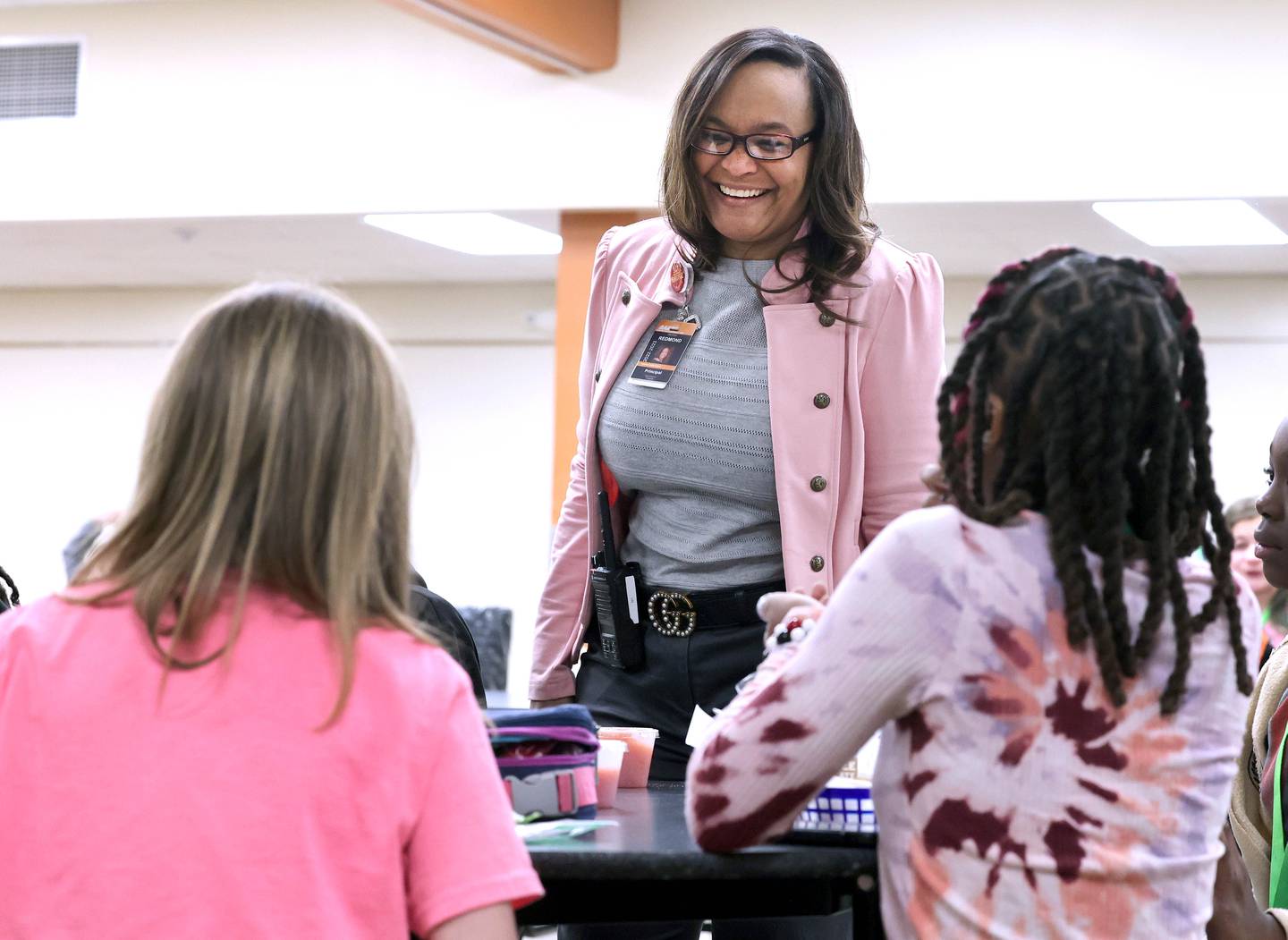 Treveda Redmond, principal at Huntley Middle School, has a laugh with sixth-grade students during lunch Tuesday, March 14, 2023, at the school in DeKalb.