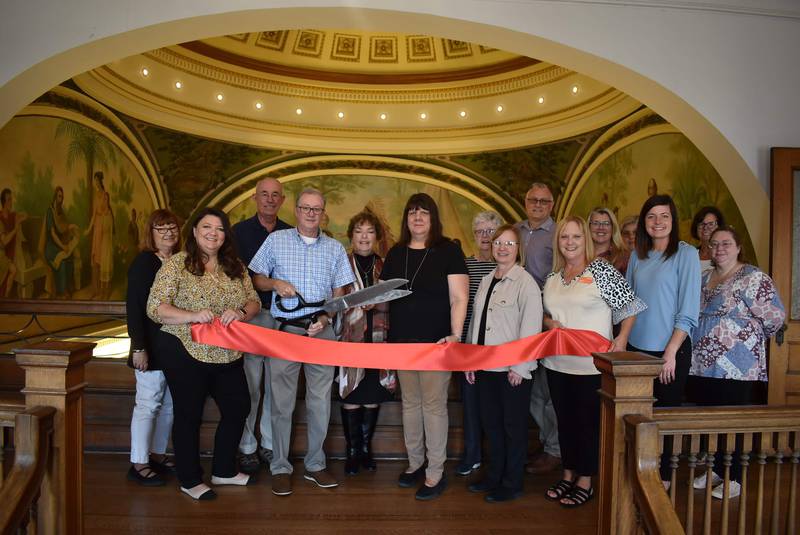 The Streator Chamber helped the Streator Public Library celebrate the restoration of its dome and murals Saturday, Sept. 23, 2023, with a ribbon cutting ceremony. Pictured (from left) are Patty Henderson, city manager executive assistant; Mayor Tara Bedei;                                 Spencer Lawrence, library board; David Reed, library board; Gloria Gubbels, library committee member; Cynthia Maxwell, library executive director; Jane Farero, board secretary; Ellen Vogel, board vice president; Gary Wheeler, board trustee; Sandy Austin, appointed trustee; Darcy Mollo, board trustee; Melissa Givens, chamber ambassador; Courtney Levy, chamber director; Lori Snell, chamber board; and Melissa Badger, technical services manager of the library.
