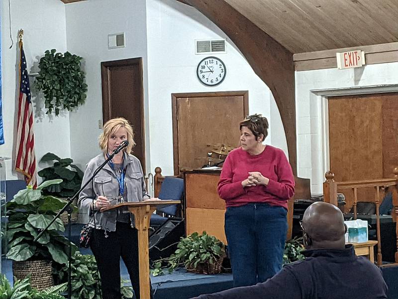 Marsha Sojka, Community Development Division Director for the Will County Land Use Department, left, and Will County Executive Jennifer Bertino-Tarrant, right, speak to those gathered at an outreach meeting about Joliet’s plan to take over the Southeast Joliet Sanitary District. The meeting was at St. John Missionary Baptist Church in Joliet on Nov. 15, 2025.