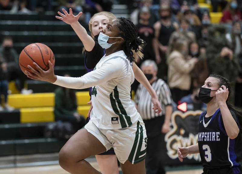 Crystal Lake South's Kree Nunnally shoots with pressure from Hampshire's Avery Cartee and Ceili Ramirez during their game on Friday, January 14, 2022 at Crystal Lake South High School.