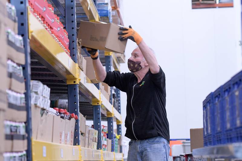 Butch Burrell of Woodridge sorts dry goods while volunteering at the Northern Illinois Food Bank in Geneva Mar. 31.
