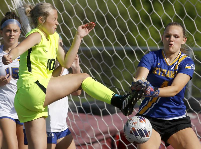 Johnsburg goalie Sophie Person tries to knock the ball away from Richmond-Burton's Maddie Seyller during the Kishwaukee River Conference Girls Soccer Tournament Championship Match on Wednesday, May 1, 2024, at Richmond-Burton High School.