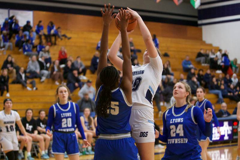 Downers Grove South's Megan Ganschow puts the shoot up over Lyons Nora Ezike at the West Suburban Conference Crossover Championship on Wednesday, Feb.8,2023 in Addison.