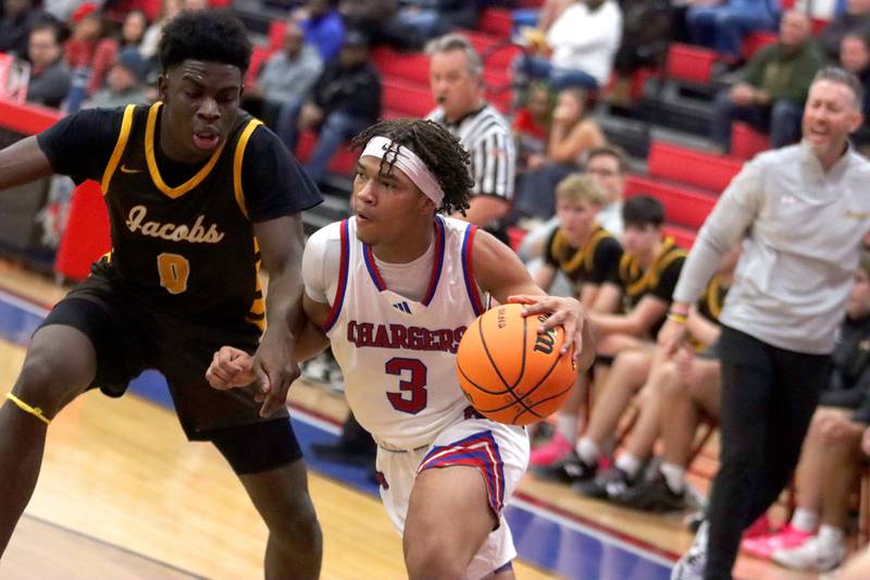 Jacobs’ Samson Averehi, left, guards Dundee-Crown’s Rasheed Trice in varsity boys basketball on Friday, Dec. 12, 2025, at Dundee-Crown High School in Carpentersville.