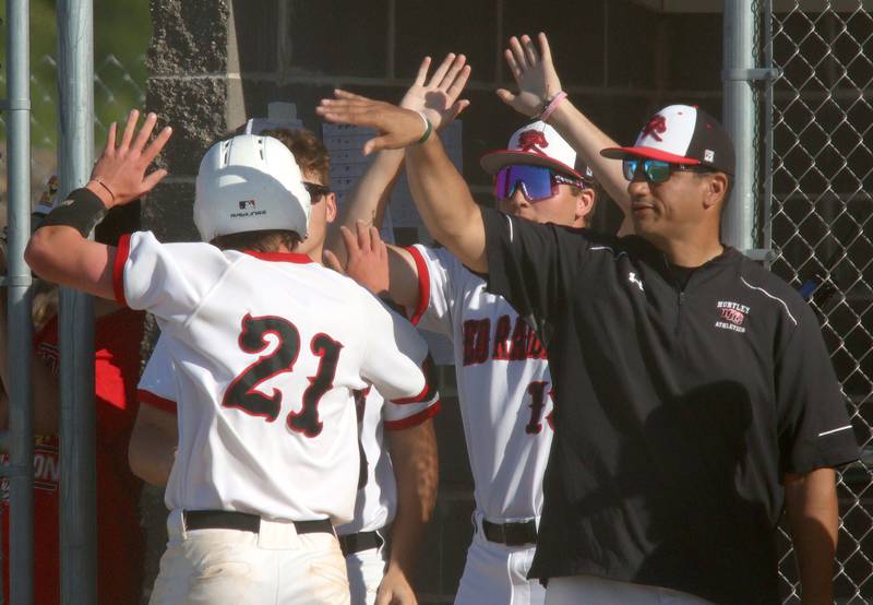 Huntley’s Marco Stawski (21) is greeted after scoring against Barrington in sectional semifinal baseball action at Hampshire Wednesday.