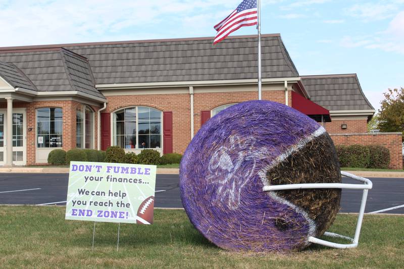 Bales and PVC, a winning combination: Stillman Bank roots for the Rochelle High School Hubs football team with its bale, with PVC piping attached to make it look like a helmet. The bale was part of the 2025 Hay Bale Trail in Rochelle throughout October.