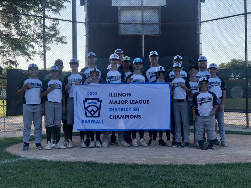 The Oglesby Major League baseball team poses with its banner after winning the District 20 title on Sunday.