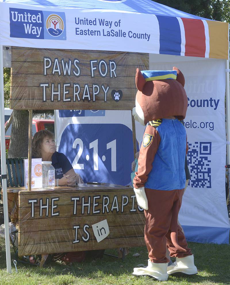 Chase the Deputy Dog for the Ottawa Police Department checks out the therapist Sunday, Oct. 6, 2024, at the United Way booth during the annual Bill’s Barktoberfest on the Jordan block in Ottawa.