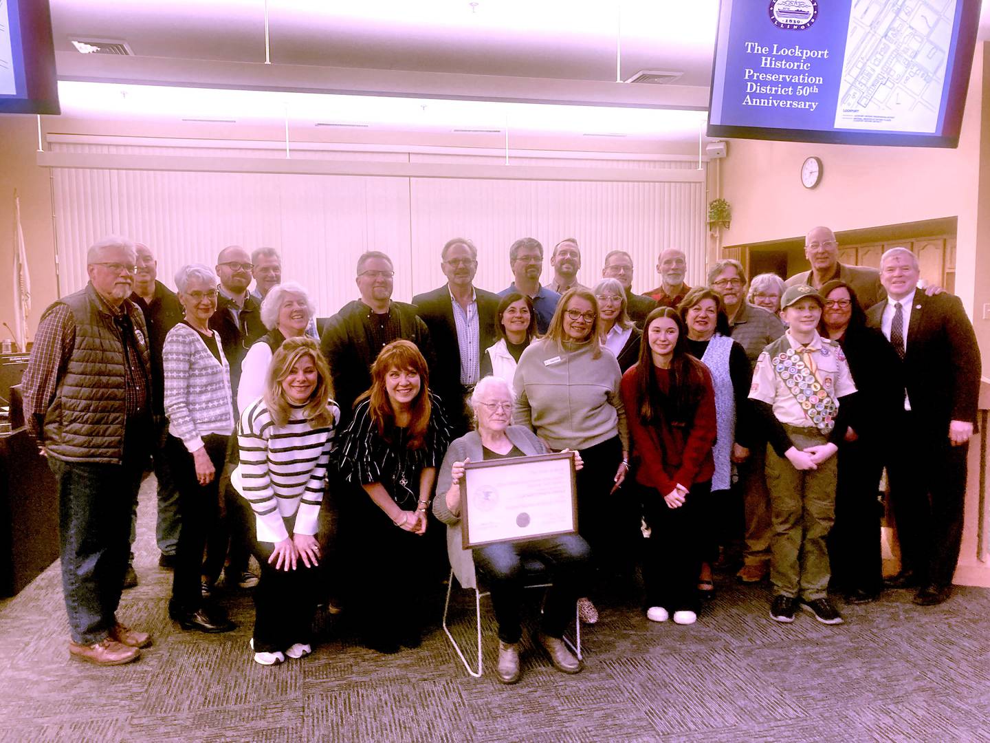 The Lockport City Council and staff pose for pictures with members of the Lockport Area Genealogical and Historical Society, community volunteers, and former staff members to celebrate the 50th Anniversary of the city's Historical Preservation District's recognition. 
Wednesday, March 5, 2025.