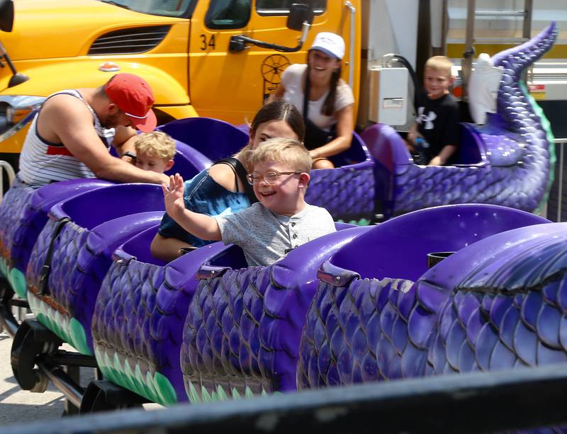 Five-year-old Leo Gius of Naperville waves to his grandmother at the Windmill City Festival in Batavia on Saturday, July 13, 2024 in Batavia.