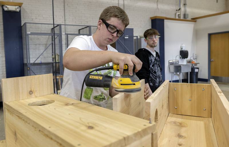 Bryce Kooy sands down an edge of his wood duck house Monday, Nov. 10, 2025, in class at Sterling High.