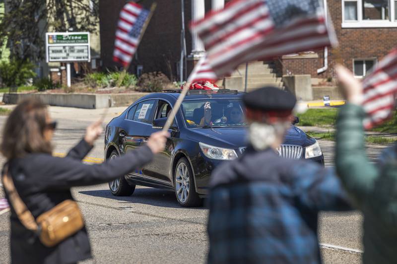 Well wishers wave flags to celebrate passing veterans Saturday, April, 26, 2025. Dixon VFW Post 540 held a Vietnam veteran parade down Galena Avenue to recognize those veterans who didn’t receive the thank you they deserved.