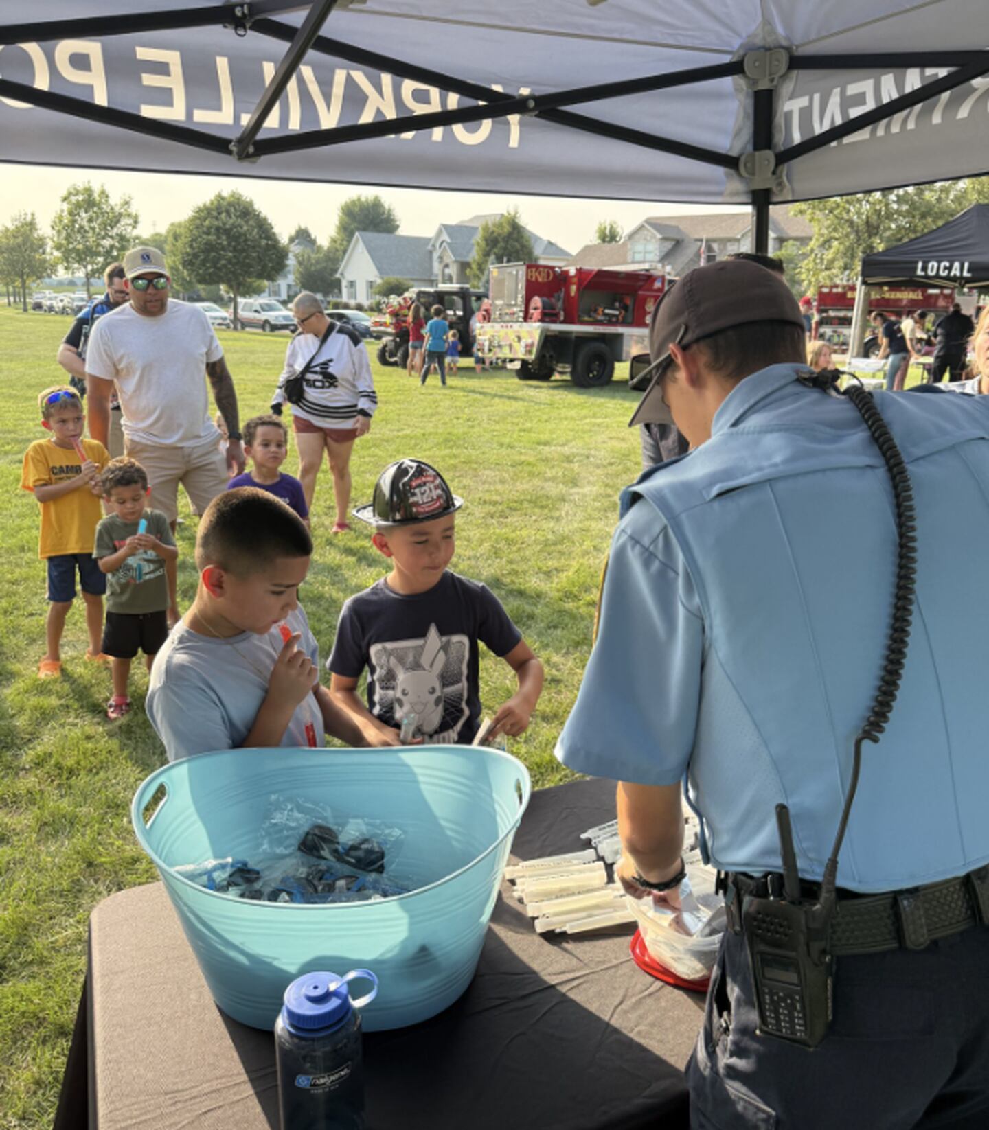 Yorkville Police Department Community Service Officer Tyler Madsen greets kids during the National Night Out event in Yorkville.
