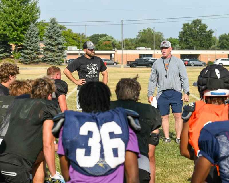 Kaneland's varsity head football coach, Michael Thorgesen, left, and Oswego's varsity head football coach Brian Cooney welcomes everyone to the start of a joint practice on Thursday July 10, 2025, held at Oswego High School.