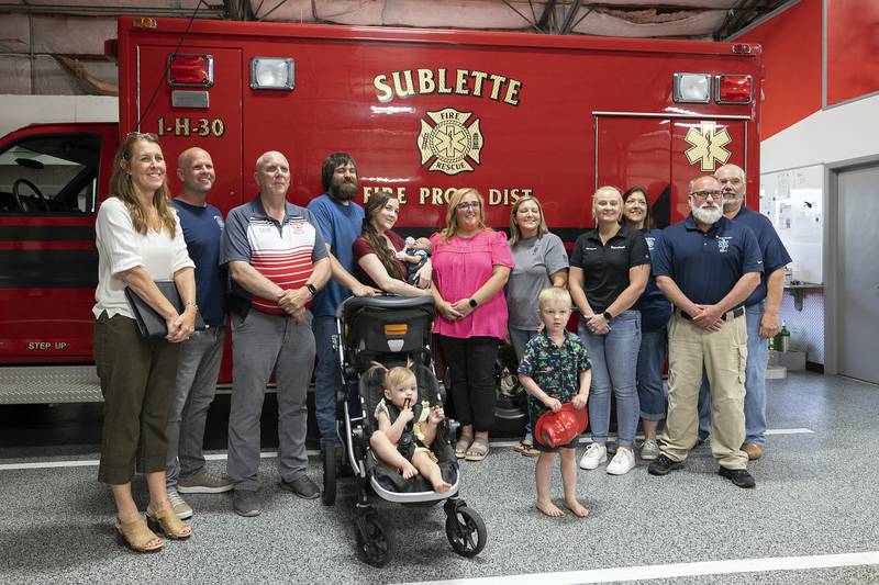 Mercy Health rewarded Lee County 911 and Sublette Fire with stork pins for helping the Edwards family through a birth. Pictured: 911 Director Shelley Dallas (left), Sublette Fire Nick Dinges, Sublette Fire Chief Kevin Schulz, Ryan, Cheyenne and Wilder Edwards with daughter Atley, 2, and son River, 4. Dispatchers Kelly Boos and Jesica Knipple, Paramedic Jennifer Stampfler, EMS Captain Mary Ehlers, Dr. John Pakiela and helpful neighbor Roger Wittenauer.