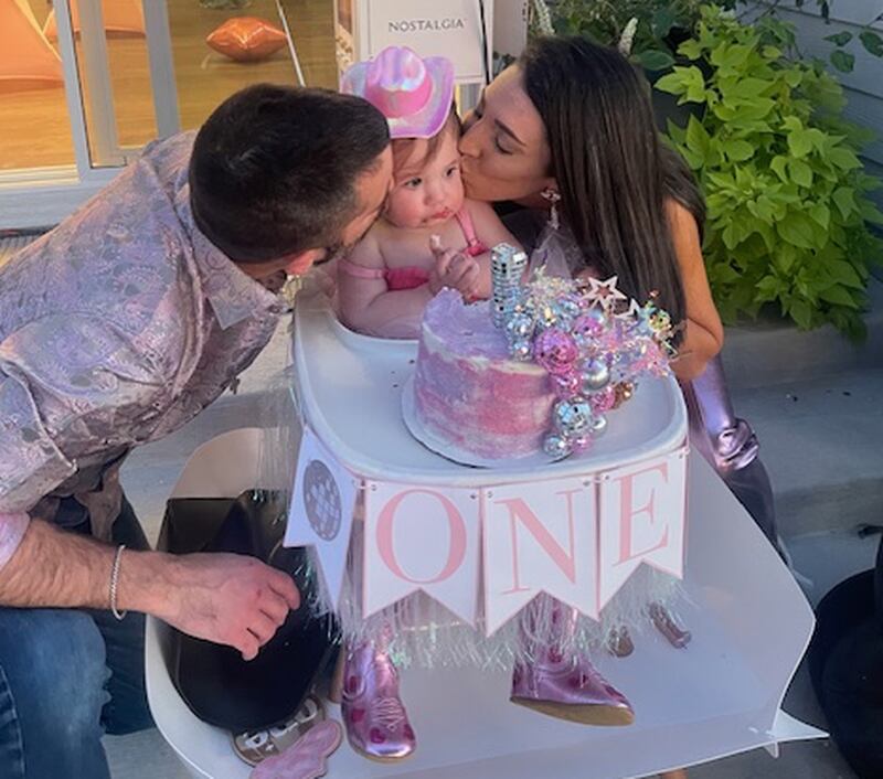 After undergoing successful chemotherapy for leukemia and then successful IVF treatments, Ioanna Lo Destro (right) and her husband, Grant Lo Destro (left), celebrate their daughter Penelope's first birthday in Batavia.