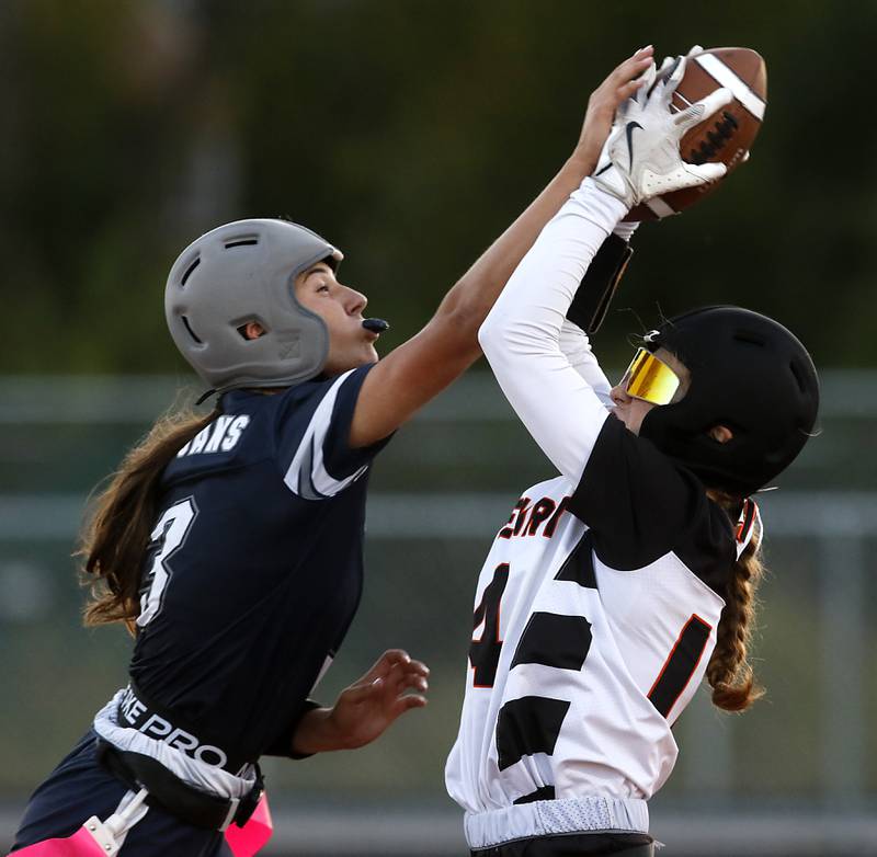 Cary-Grove's Kennedy Manning tries to break up a pass to McHenry's Morgan Frederick during the IHSA McHenry Regional girls flag football championship game on Wednesday, Oct. 8, 2025, at McCracken Field in McHenry.