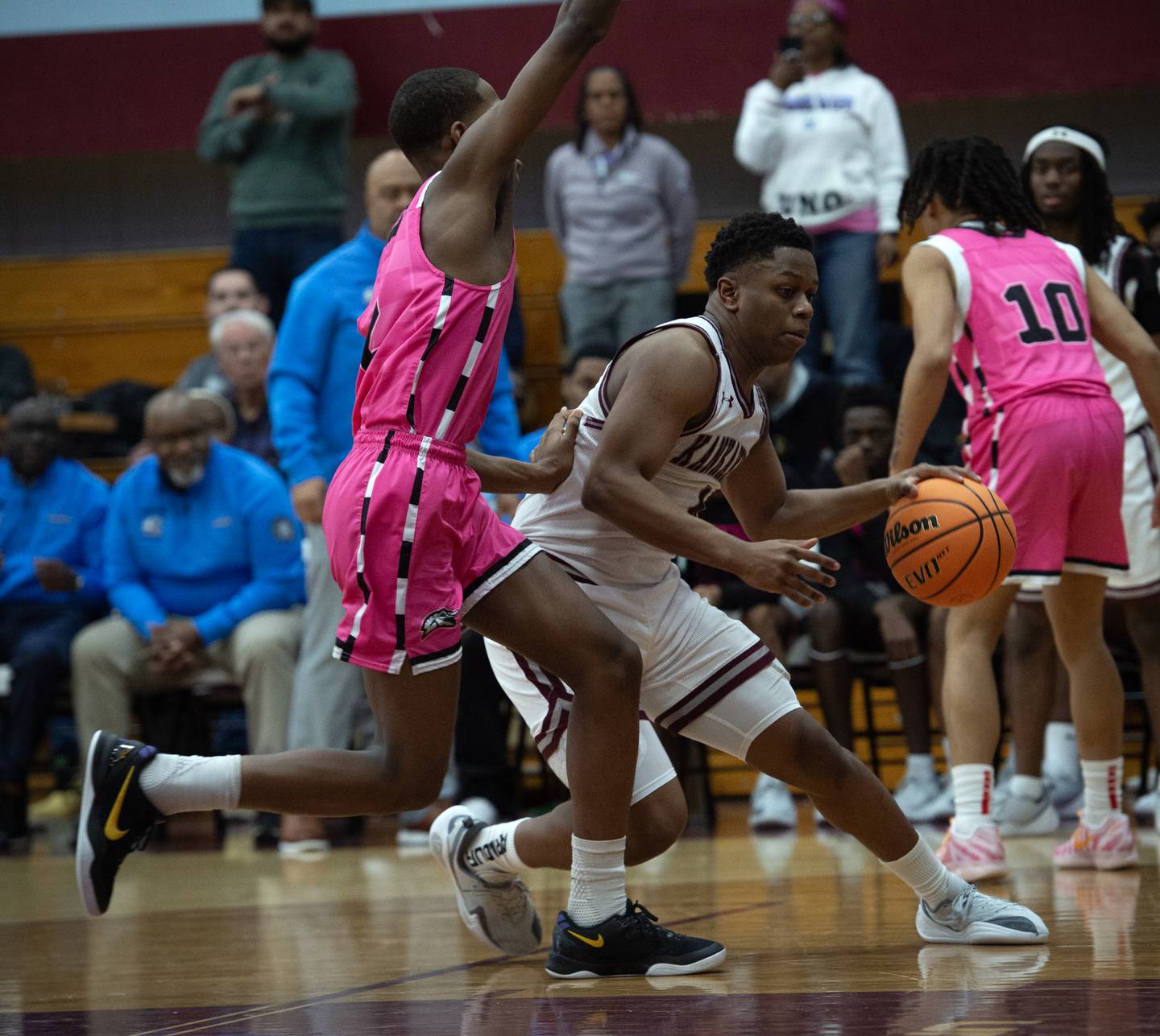 Kankakee's Myair Thompson controls the ball near the net as Rich Township's Jonathan Booker, left, guards in a game on Friday, February 6, 2026.