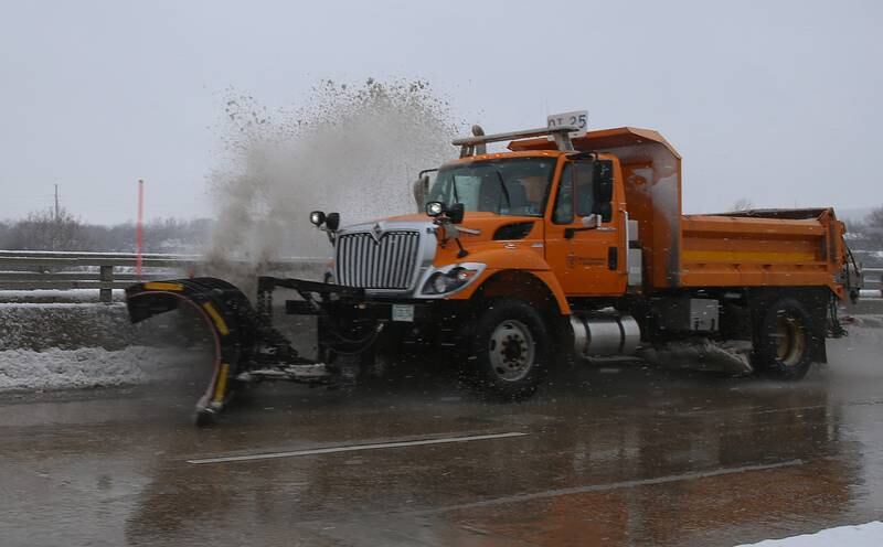 A Illinois Department of Transportation snow plow pushes snow on the Veterans Memorial Bridge on Tuesday, Jan. 9, 2024 in Ottawa.