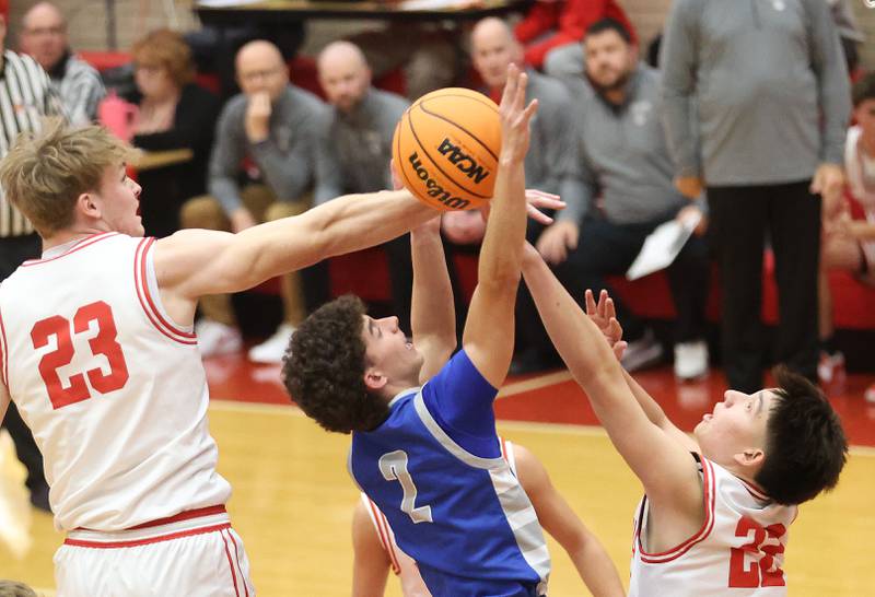 Ottawa's Owen Sanders and teammate Dom Parks block Princeton's Stihl Brokaw's shot under the hoop during the Dean Riley Shootin' The Rock Thanksgiving Tournament on Monday Nov. 24, 2025 in Kingman Gymnasium at Ottawa High School.