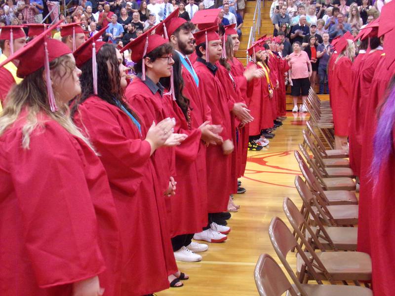 A row of graduating seniors give applause Sunday, May 21, 2023, during the Streator High School graduation ceremony at the Pops Dale Gymnasium.