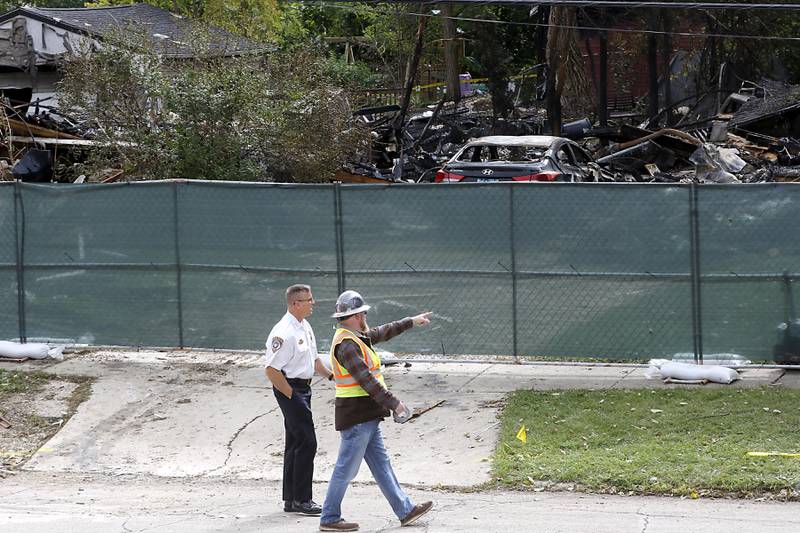 Woodstock Chief of Police John Lieb  looks at the damage in the 300 block of Lincoln Avenue on Tuesday, October 10, 2023, after an explosion following a gas leak in the area leveled one home as caused several fires.