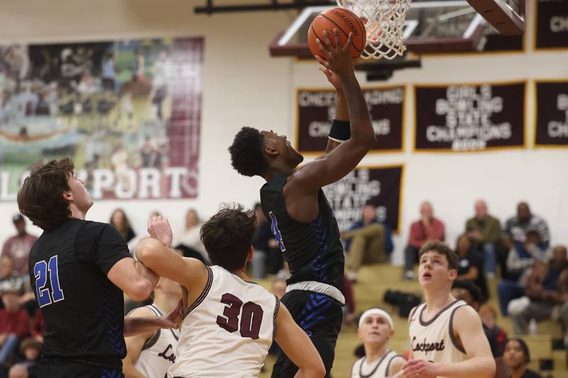 Lincoln-Way East’s Karson Thomas lays in a shot against Lockport on Friday, Dec. 1, 2023 in Lockport.