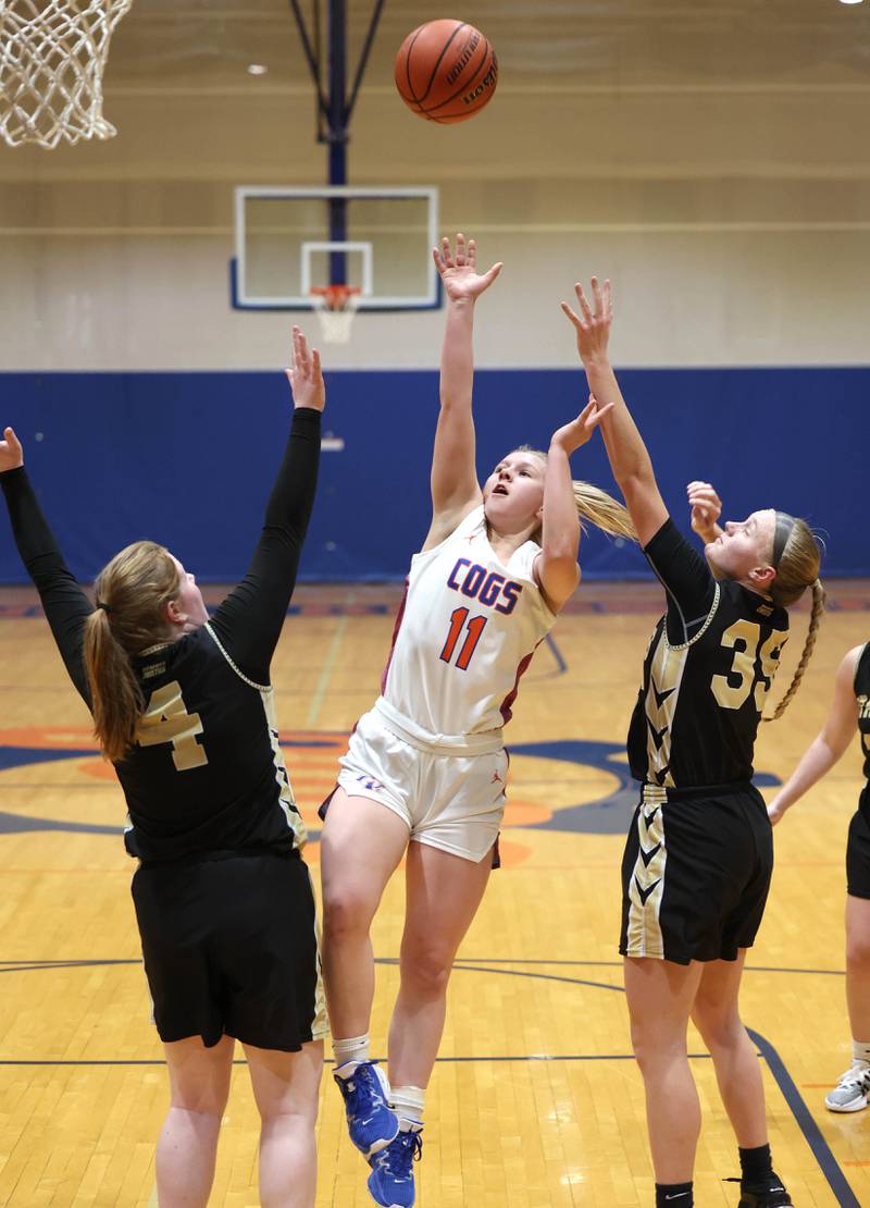 Genoa-Kingston's Emily Trzynka shoots between two Rockford Christian defenders during their game Friday, Jan. 13, 2023, at Genoa-Kingston High School.