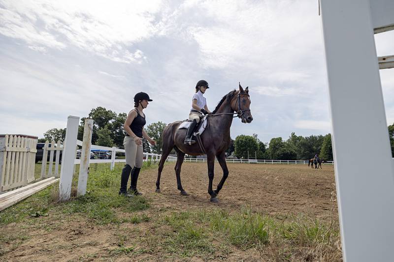 Talisa Thomas works with Linnea Thorngren on her form Friday, July 14, 2023 at the Whitside County 4H fair during horse show portion of the weekend.