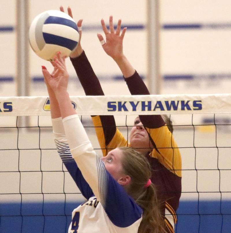 Richmond-Burton’s Reagan Wisniewski, back, and Johnsburg’s Adelaide Bruns battle at the net in varsity girls volleyball at Johnsburg High School in Johnsburg on Thursday, August 25, 2025.