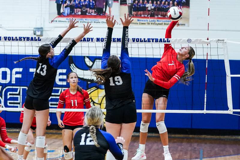 Aurora Christian's Hope Wagner (7) goes up for a kill against Newark’s Tessa Kot (13) and Isabella Dierzen (19) during a non-conference match at Newark High School on Tuesday, Sept. 9, 2025.