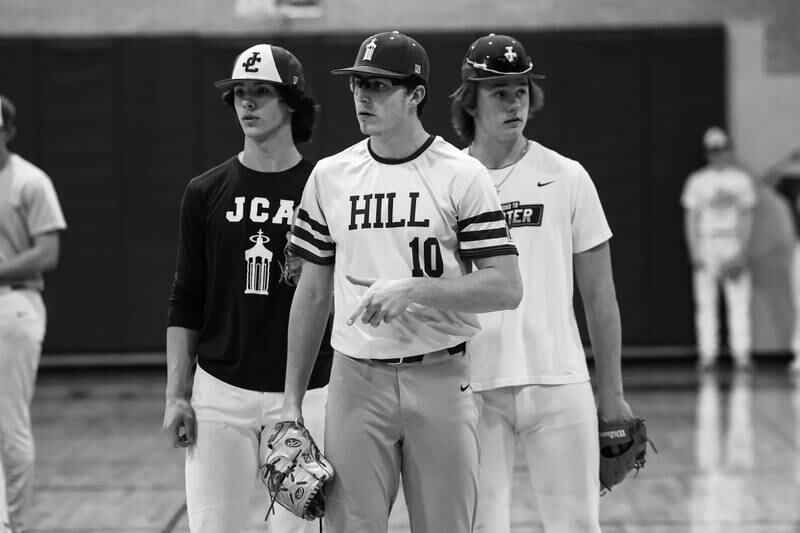 Three of the states top players Joliet Catholic’s Aidan Hayse (left), TJ Schlageter and Trey Swinderski stand together before working on throwing indoors after their game was rescheduled due to weather on Tuesday, March 14th, 2023 in Joliet.
