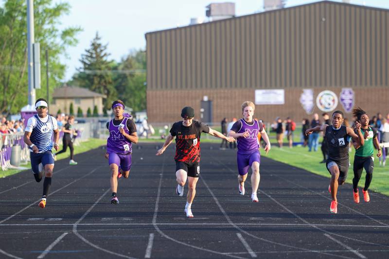 St. Anne's Aden Pinson, center, and Kankakee's George Noble, second from right, stride out as they near the finish line during the 100-meter race at the Manteno Track Invite on Friday, April 24, 2026. Due to a starting block issue, the heat was rerun, with Noble taking first and Manteno's Alexsander Lane, left of center, placing second and Pinson taking third.